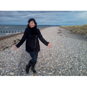 Kerrie Noor celebrating a story finished on a beach in Scotland